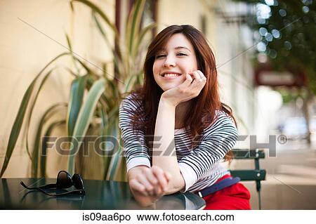 Portrait of young woman at sidewalk cafe View Large Photo Image Picture - Portrait of young woman at sidewalk cafe. Fotosearch