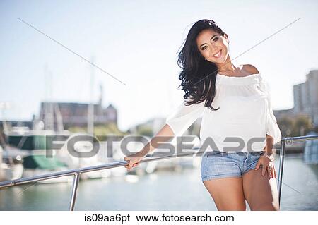 Portrait of young woman leaning on yacht railings, San Francisco, California, USA View Large Photo Image Stock Photograph - Portrait of young woman leaning on yacht railings, San Francisco, California, USA. Fotosearch