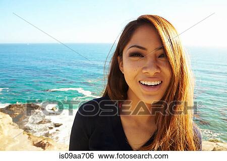 Stock Photograph - Portrait of young woman smiling, Palos Verdes, California, USA. Fotosearch