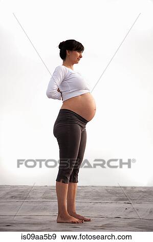 Stock Photo - Pregnant woman in yoga mountain pose. Fotosearch