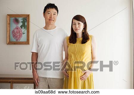 Stock Image - Pregnant woman with man, portrait. Fotosearch