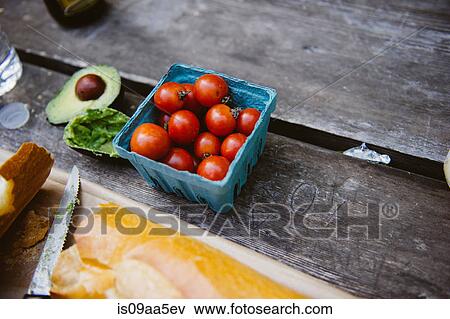Punnet of fresh tomatoes on table View Large Photo Image Stock Photo - Punnet of fresh tomatoes on table. Fotosearch