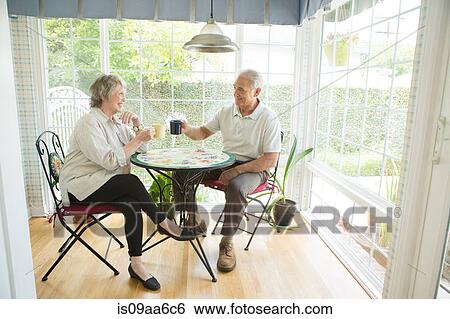 Senior couple at table in conservatory View Large Photo Image Stock Photograph - Senior couple at table in conservatory. Fotosearch