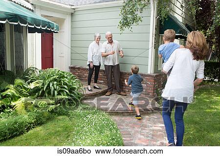 Senior couple greeting family at home View Large Photo Image Picture - Senior couple greeting family at home. Fotosearch