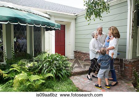 Senior couple greeting family at home View Large Photo Image Stock Photo - Senior couple greeting family at home. Fotosearch