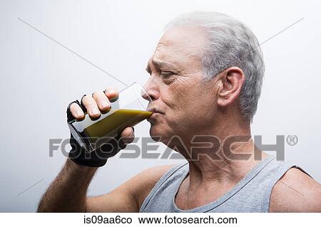 Senior man drinking smoothie from glass View Large Photo Image Picture - Senior man drinking smoothie from glass. Fotosearch