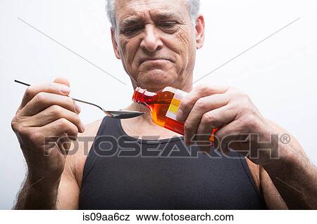 Senior man pouring medicine from bottle View Large Photo Image Stock Photo - Senior man pouring medicine from bottle. Fotosearch