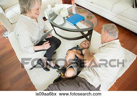 Senior man tickling grandson on rug View Large Photo Image Stock Photo - Senior man tickling grandson on rug. Fotosearch