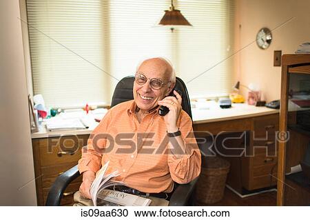 Senior man using telephone in home office, smiling View Large Photo Image Stock Image - Senior man using telephone in home office, smiling. Fotosearch