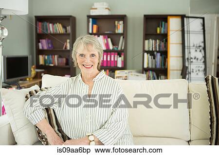 Senior woman on sofa, portrait View Large Photo Image Stock Photography - Senior woman on sofa, portrait. Fotosearch