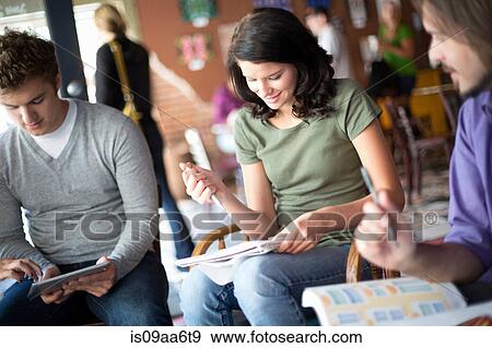 Stock Photo - Small group of people studying in cafe. Fotosearch