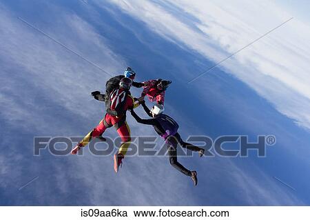 Stock Image - Small group of skydivers in formation. Fotosearch