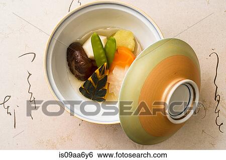 Stock Photograph - Still life of bowl and lid with fresh steamed vegetables. Fotosearch