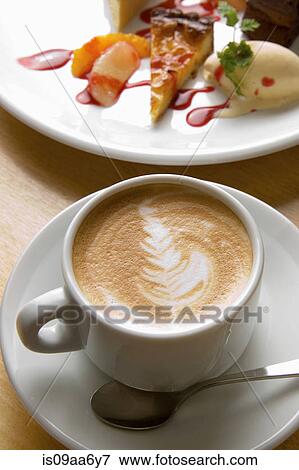 Stock Photo - Still life of frothy coffee with plate of tart and ice cream. Fotosearch