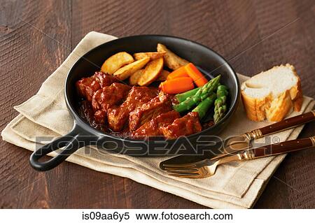 Still life of pan with meat, chips and vegetables View Large Photo Image Stock Photography - Still life of pan with meat, chips and vegetables. Fotosearch
