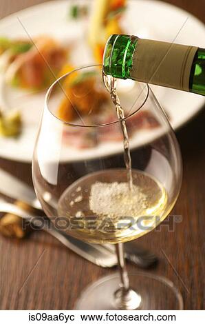 Still life of white wine pouring into glass View Large Photo Image Stock Image - Still life of white wine pouring into glass. Fotosearch