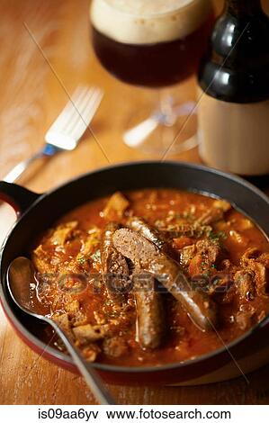 Stock Photo - Still life with sausage stew and beer. Fotosearch