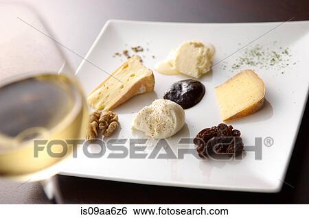 Stock Photograph - Still life with white wine and selection of cheeses. Fotosearch