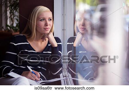 Teenage girl distracted whilst studying in cafe View Large Photo Image Stock Photography - Teenage girl distracted whilst studying in cafe. Fotosearch