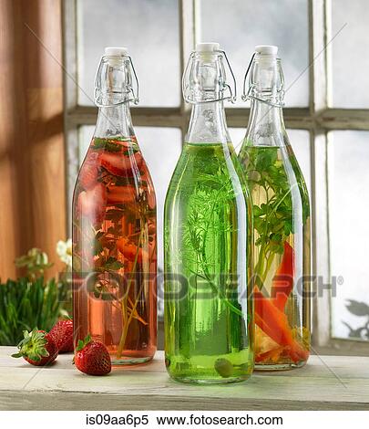 Three bottles of pickled herbs on windowsill View Large Photo Image Stock Photography - Three bottles of pickled herbs on windowsill. Fotosearch