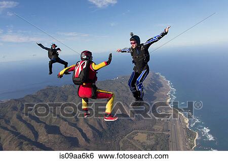 Three formation skydivers free falling View Large Photo Image Stock Photograph - Three formation skydivers free falling. Fotosearch
