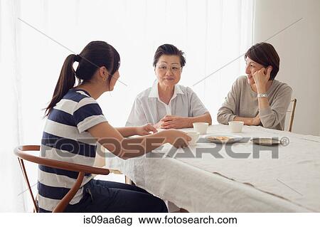 Stock Image - Three generation family at table. Fotosearch
