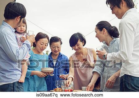 Three generation family eating meal outdoors View Large Photo Image Stock Photography - Three generation family eating meal outdoors. Fotosearch