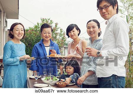 Three generation family eating outdoors, portrait View Large Photo Image Stock Photography - Three generation family eating outdoors, portrait. Fotosearch