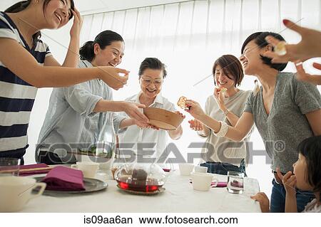 Three generation family laughing at mealtime View Large Photo Image Picture - Three generation family laughing at mealtime. Fotosearch