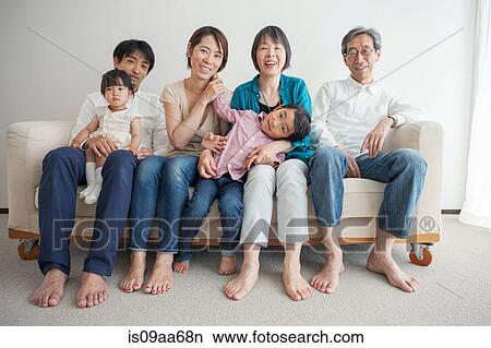 Three generation family sitting on sofa, portrait View Large Photo Image Picture - Three generation family sitting on sofa, portrait. Fotosearch