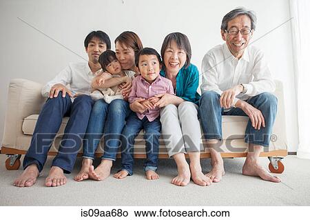 Three generation family sitting on sofa, portrait View Large Photo Image Picture - Three generation family sitting on sofa, portrait. Fotosearch