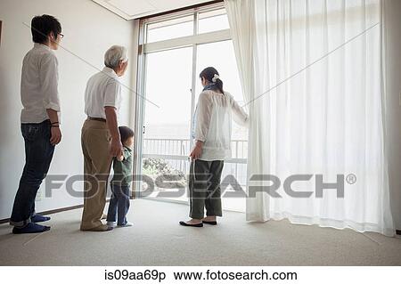 Three generation family standing by window View Large Photo Image Stock Photography - Three generation family standing by window. Fotosearch