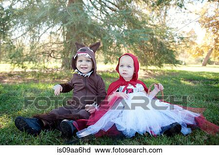 Toddler twins in woods dressed up as red riding hood and wolf View Large Photo Image Stock Image - Toddler twins in woods dressed up as red riding hood and wolf. Fotosearch