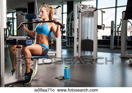 Picture - Woman pulling weights. Fotosearch