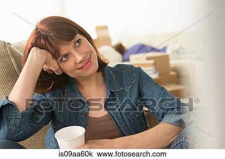 Woman taking a break whilst moving house View Large Photo Image Stock Image - Woman taking a break whilst moving house. Fotosearch