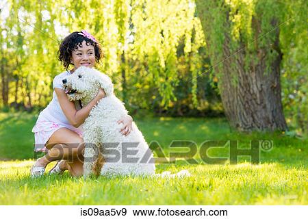 Woman with dog on grass View Large Photo Image Stock Photo - Woman with dog on grass. Fotosearch