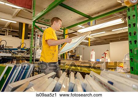 Worker carrying frame in screen printing workshop View Large Photo Image Stock Image - Worker carrying frame in screen printing workshop. Fotosearch