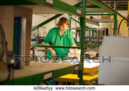 Worker preparing frame in screen printing workshop View Large Photo Image Stock Photo - Worker preparing frame in screen printing workshop. Fotosearch