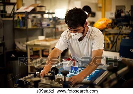 Worker with safety mask in screen printing workshop View Large Photo Image Stock Image - Worker with safety mask in screen printing workshop. Fotosearch