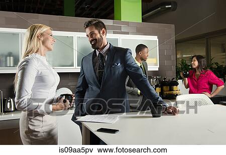 Young business colleagues chatting in office kitchen View Large Photo Image Stock Photo - Young business colleagues chatting in office kitchen. Fotosearch