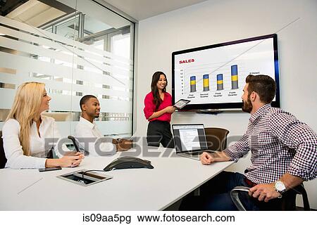 Young business colleagues looking at digital table in meeting in conference room View Large Photo Image Stock Image - Young business colleagues looking at digital table in meeting in conference room. Fotosearch