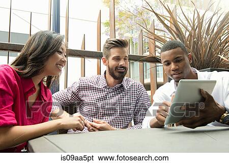 Young business colleagues looking at digital tablet in meeting View Large Photo Image Stock Photograph - Young business colleagues looking at digital tablet in meeting. Fotosearch