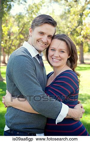Young couple embracing in park View Large Photo Image Stock Photography - Young couple embracing in park. Fotosearch