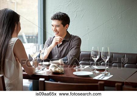 Young couple laughing in restaurant View Large Photo Image Stock Photo - Young couple laughing in restaurant. Fotosearch