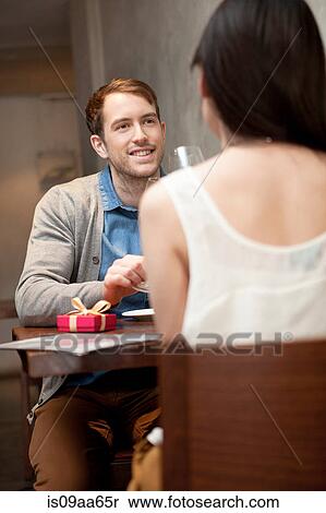 Stock Photography - Young couple sitting in restaurant. Fotosearch