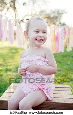 Young girl sitting outside, smiling View Large Photo Image Stock Photography - Young girl sitting outside, smiling. Fotosearch