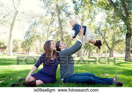 Young parents in park with female toddler View Large Photo Image Picture - Young parents in park with female toddler. Fotosearch