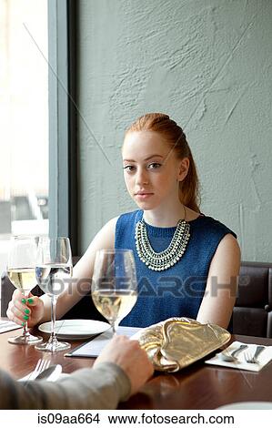 Picture - Young woman in restaurant. Fotosearch