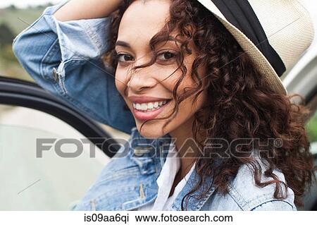 Stock Image - Young woman smiling, close up. Fotosearch