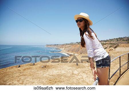 Young woman standing on fence, Palos Verdes, California, USA View Large Photo Image Stock Image - Young woman standing on fence, Palos Verdes, California, USA. Fotosearch